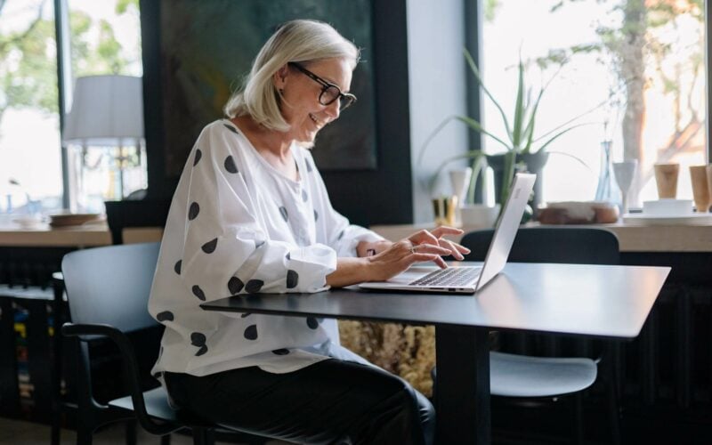 woman smiling looking at computer