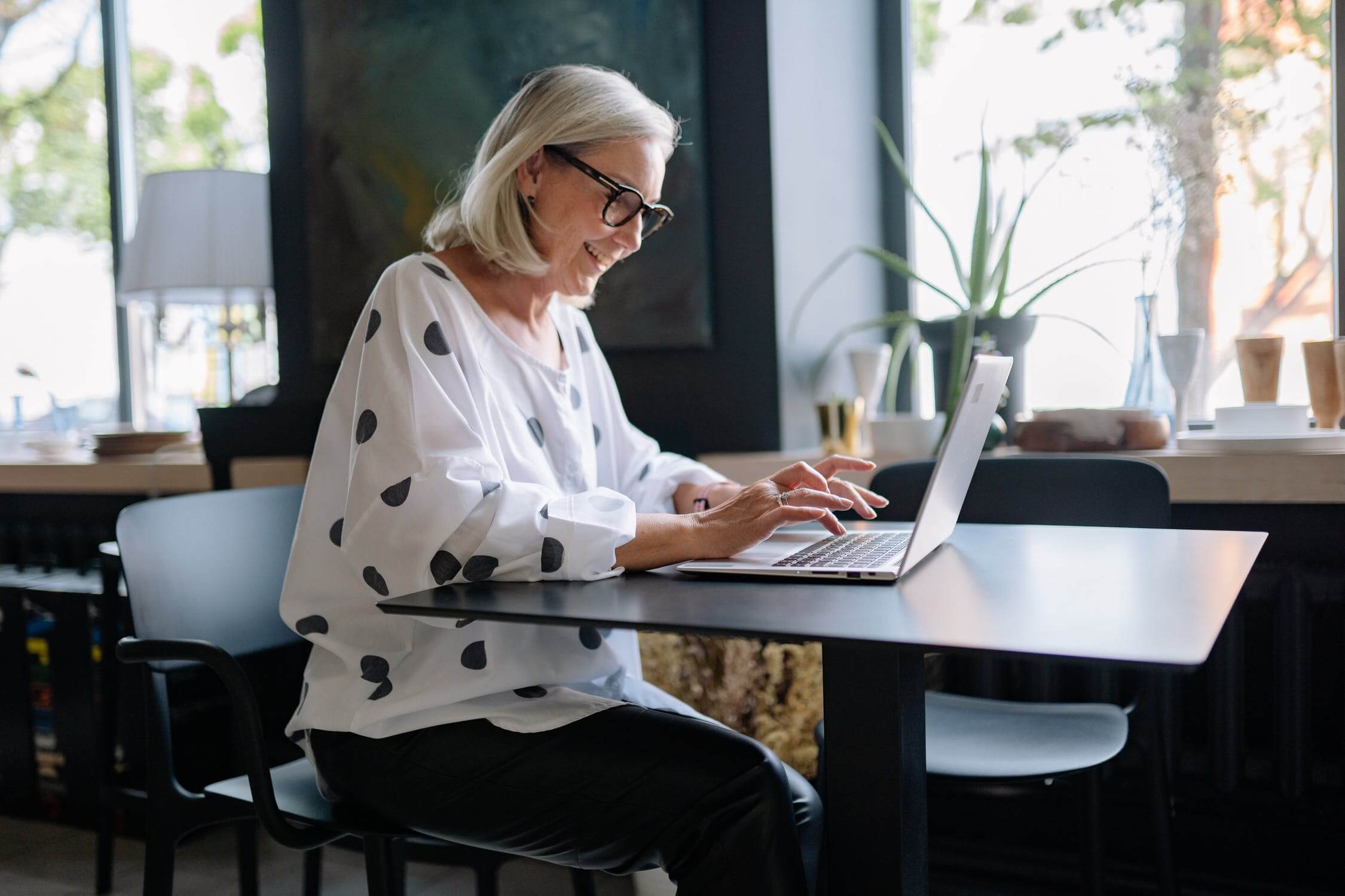 woman smiling looking at computer