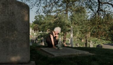 woman bending over grave