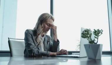 woman sitting at desk looking stressed