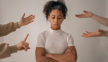 Faceless people scolding discontent black girl