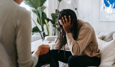 Stressed black man with dreadlocks talking to therapist