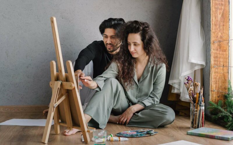 couple painting together on the floor