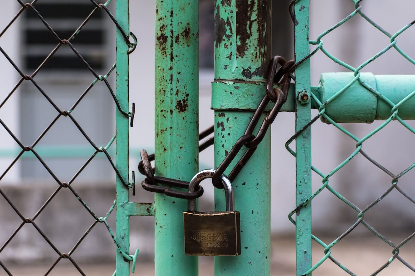 Lock on a teal fence