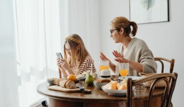 mother speaking to daughter while she looks on her phone