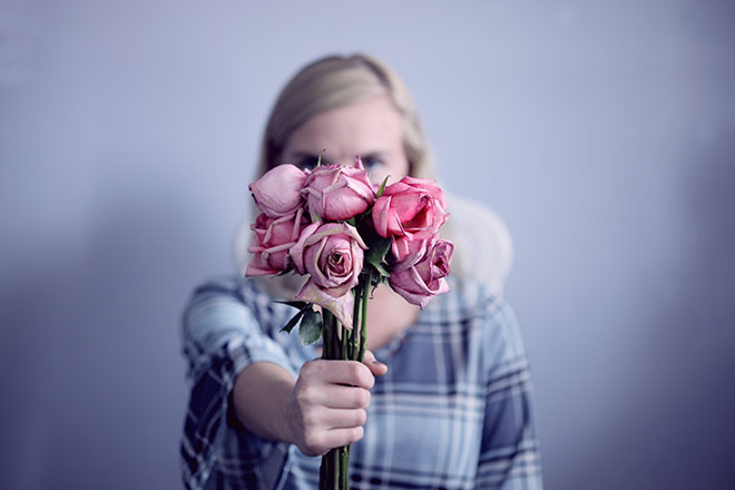 Woman holding out dried flowers