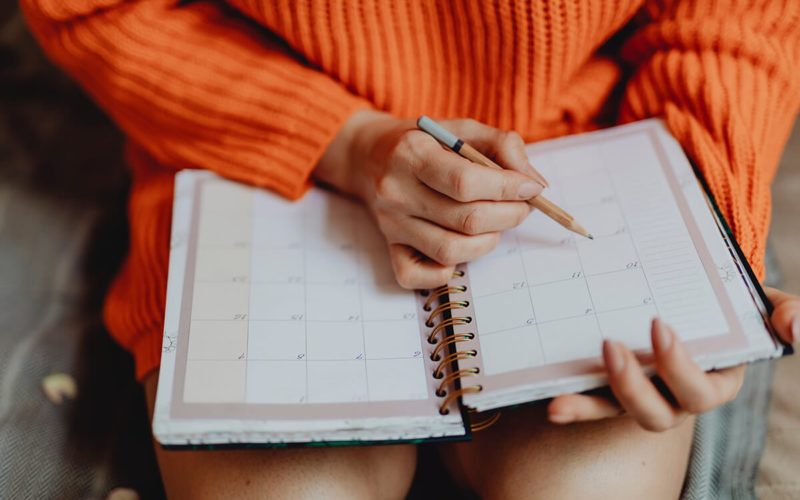 woman writing in a planner