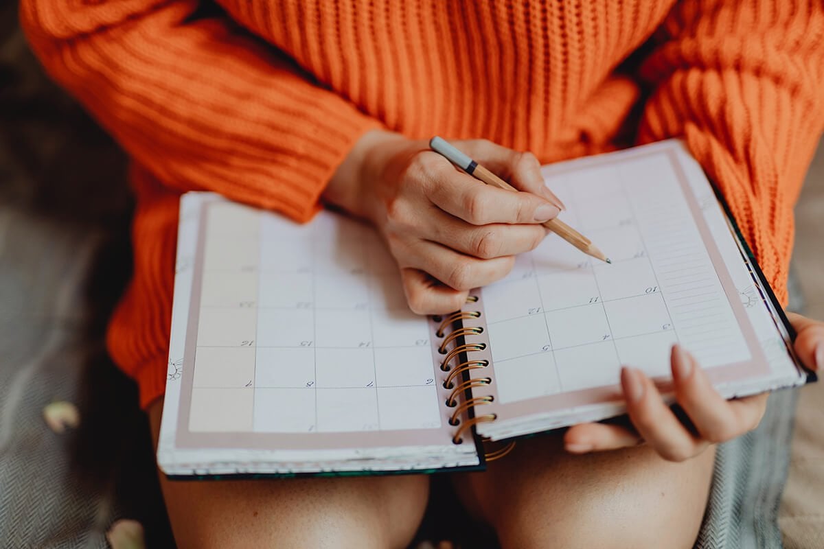 woman writing in a planner