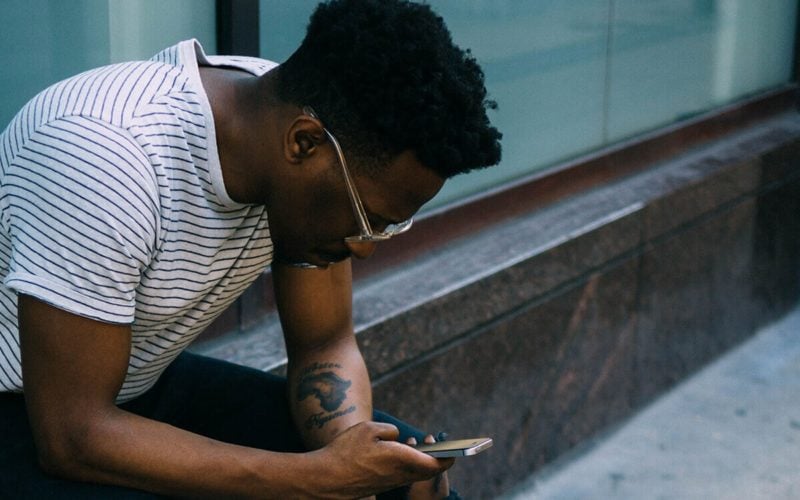 man texting therapist, online therapy