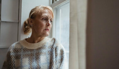 eldery woman looking out of window