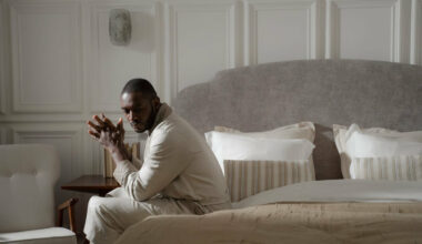 man sitting on edge of bed