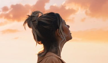 woman looking out at sunset