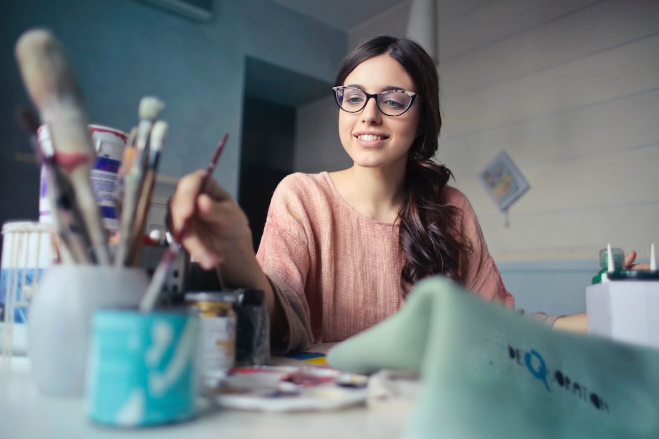 Woman painting at desk