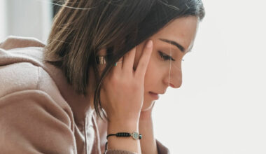 Woman sitting with head in hands