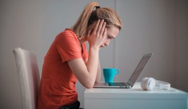 Young troubled woman using laptop at home