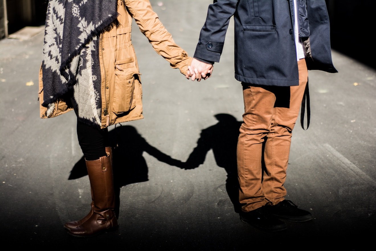 Couple holding hands on the street