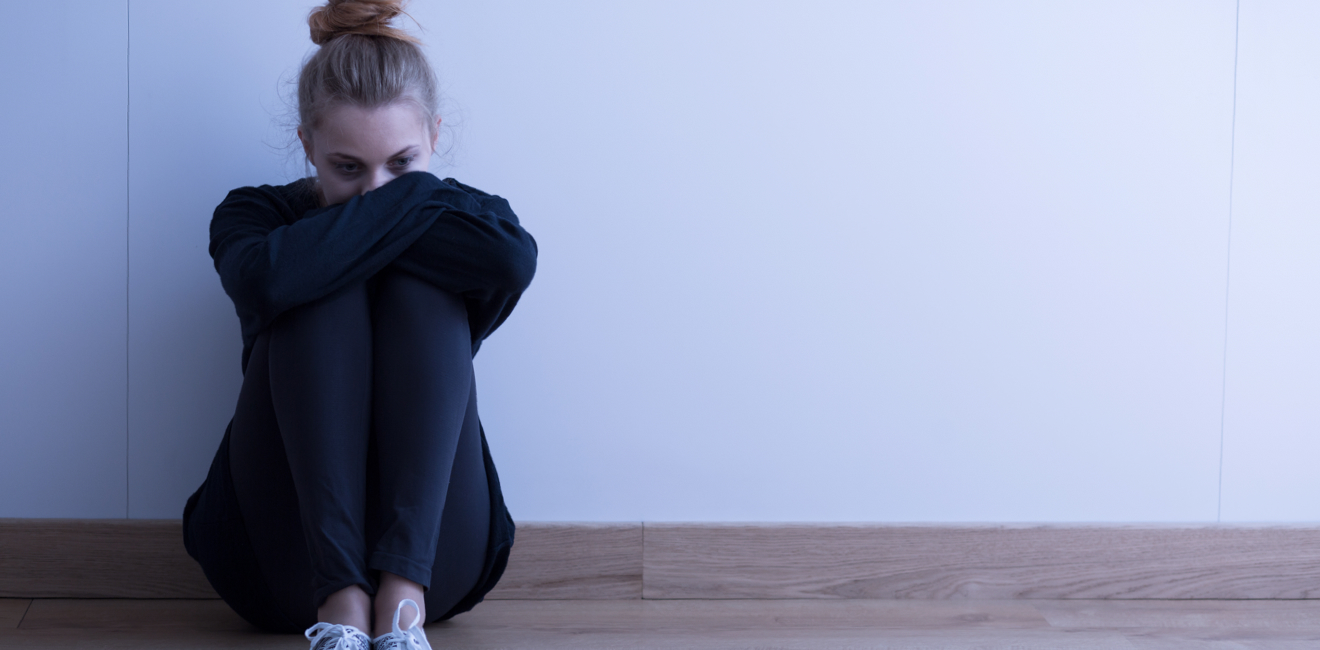 sad woman sitting on floor