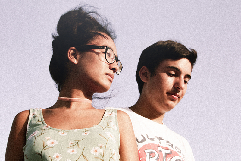 Couple standing next to each other with a lavender sky