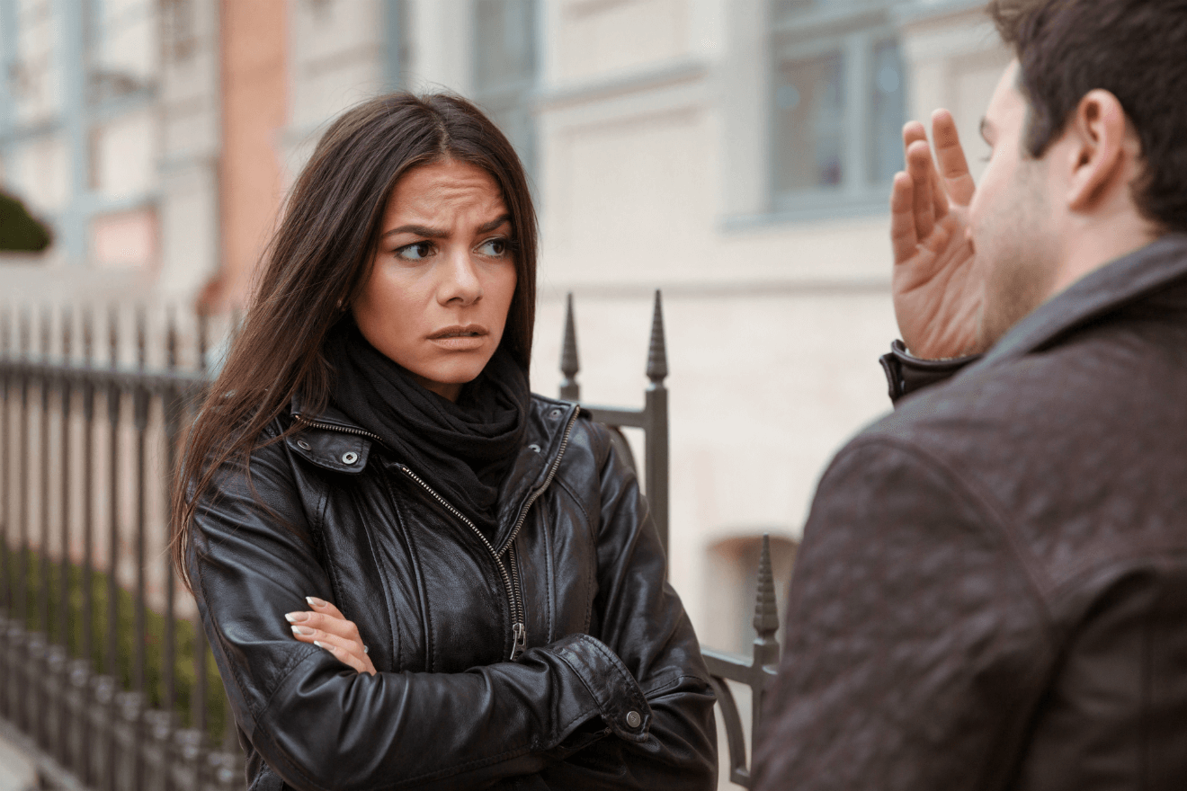 couple arguing outside on city street