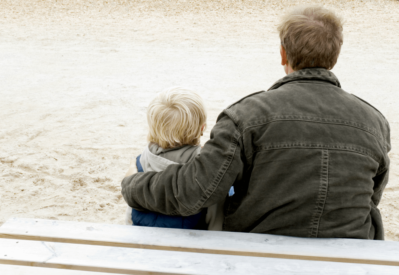 divorced dad with son on park bench