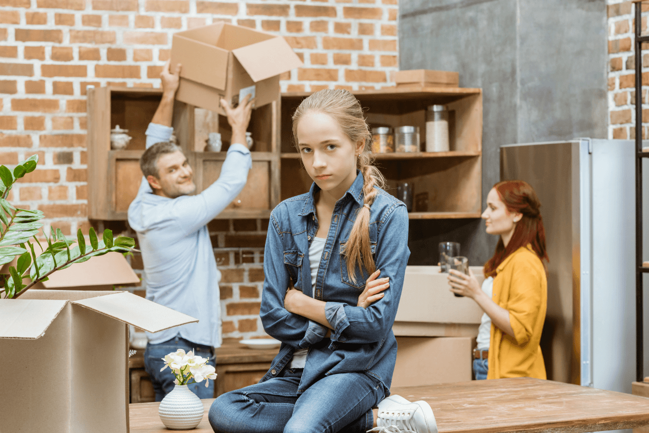 unhappy girl arms folded moving with parents