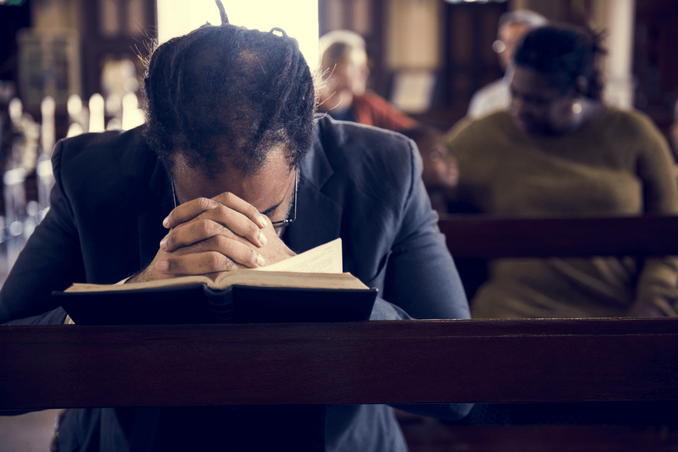 man praying church bible