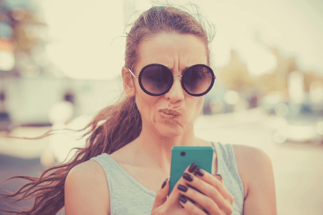 woman sunglasses texting frowning confused