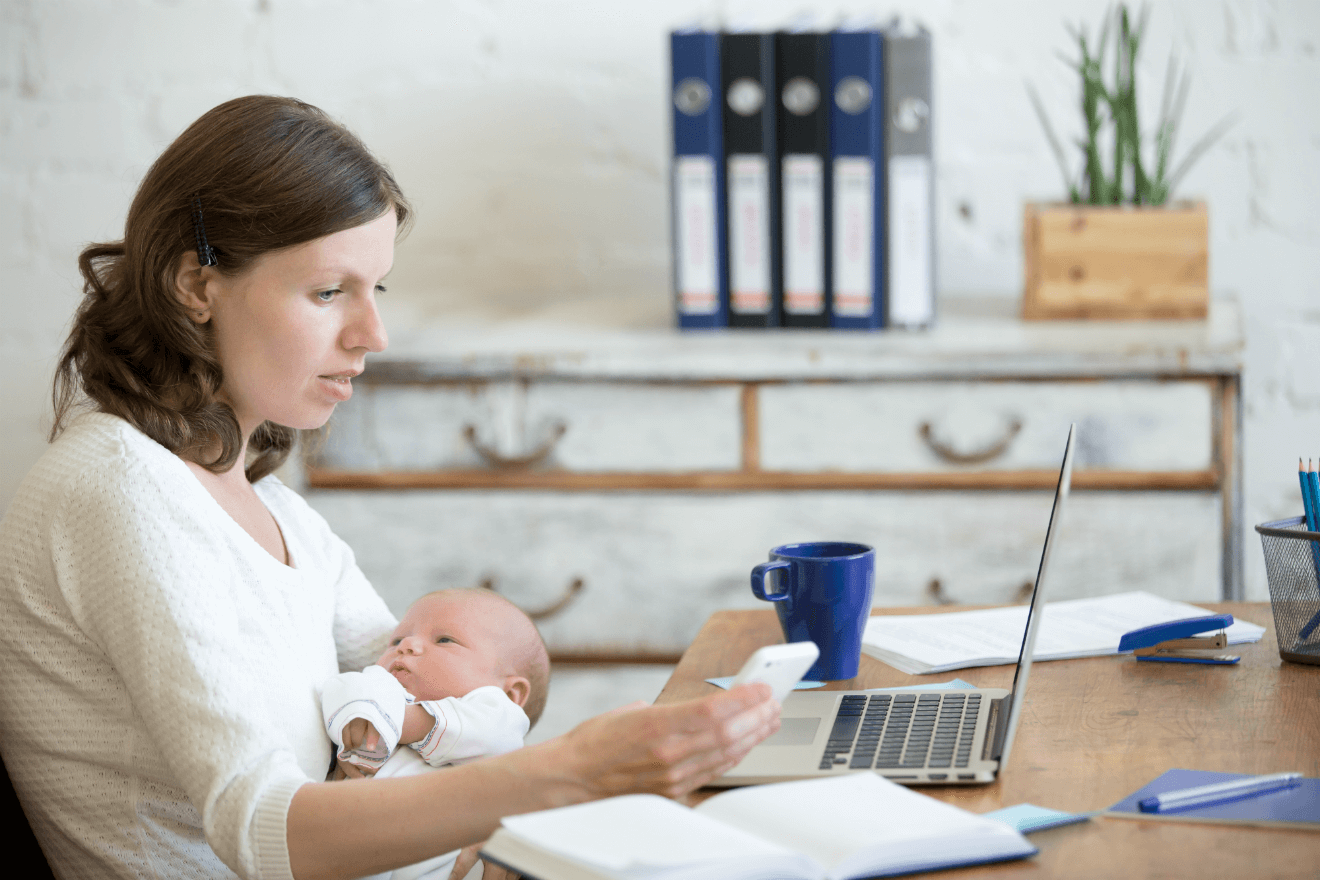 mom on phone and computer with baby