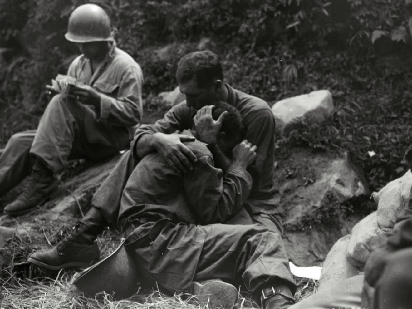 soldier holding another in his arms