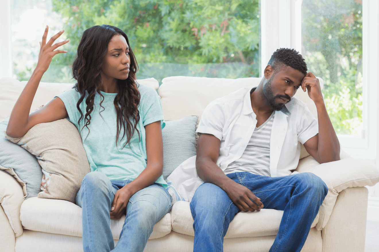 angry couple arguing on couch