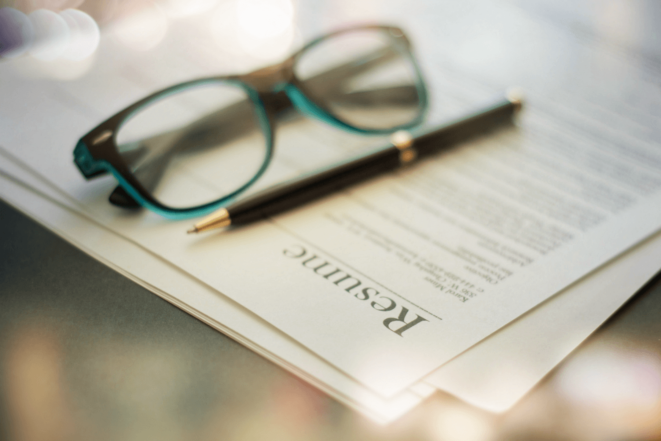 resume pen glasses on table