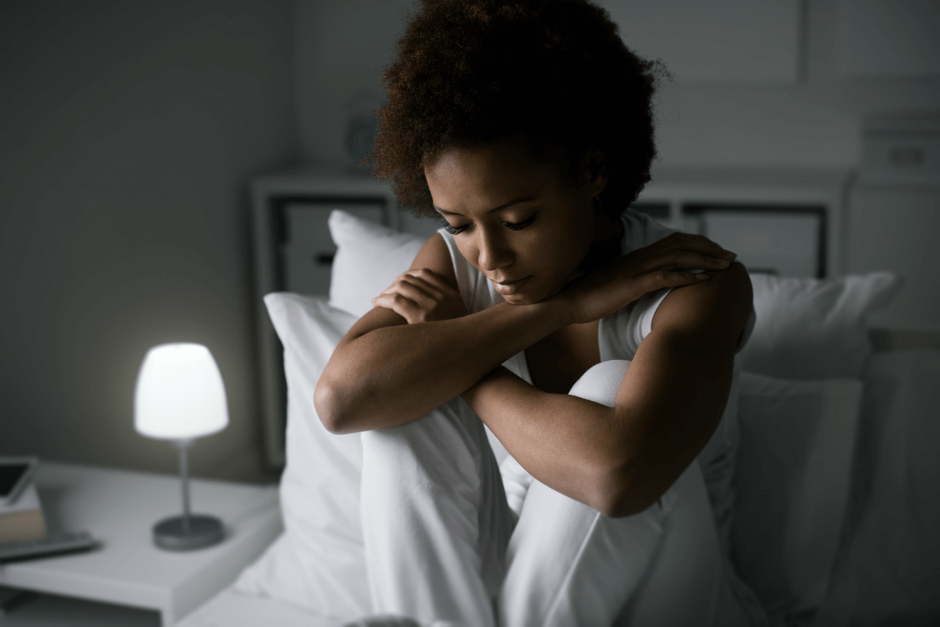 woman in bed anxiety light on